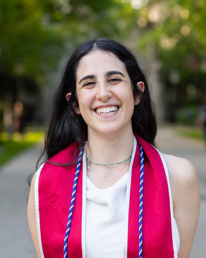 Sarah Katz smiling, wearing a University of Chicago graduation stole